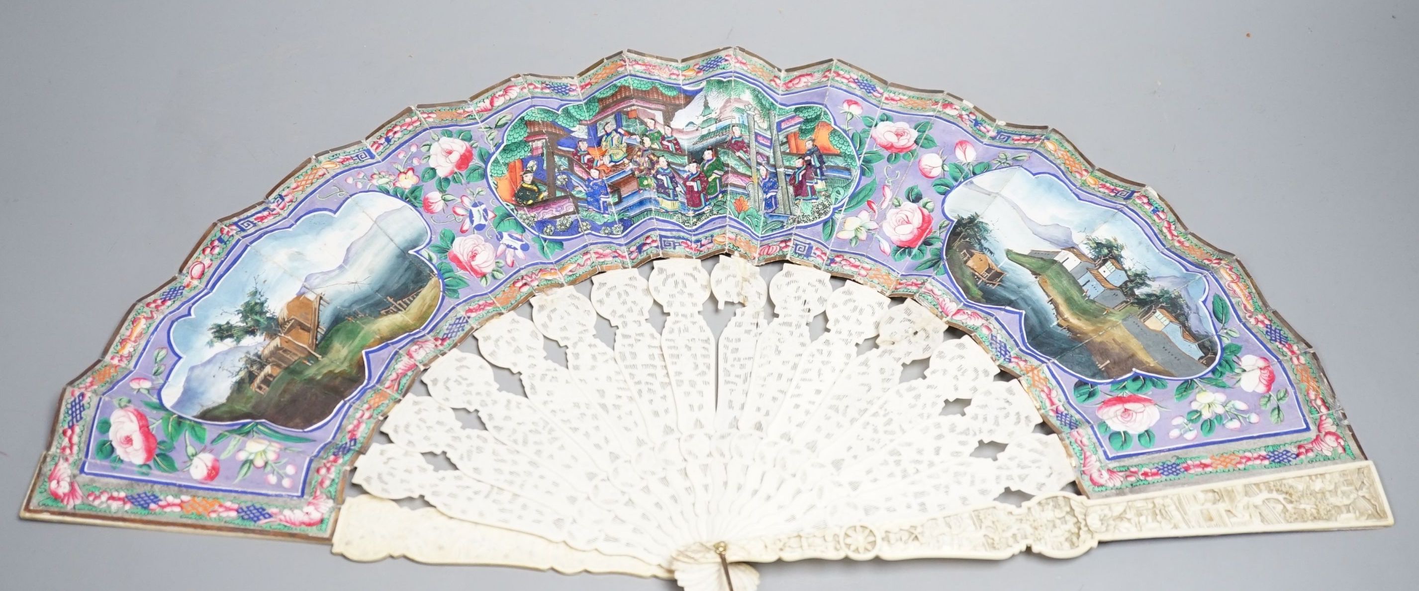 A 19th century Chinese export pierced ivory and painted paper leaf fan, in box. Fan 28cm long